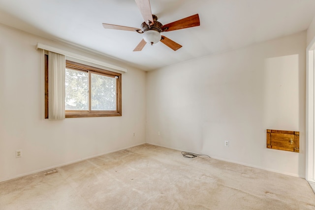 unfurnished room featuring light carpet and ceiling fan