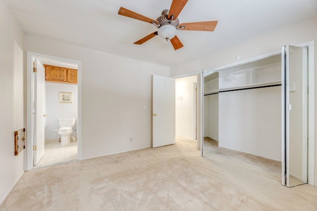 unfurnished bedroom with light colored carpet, ceiling fan, a closet, and connected bathroom