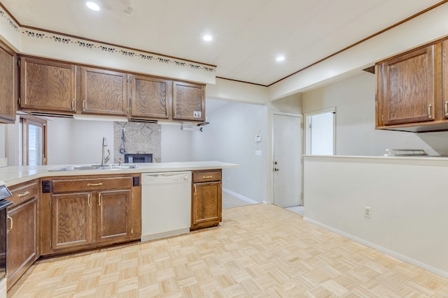 kitchen featuring kitchen peninsula, light parquet floors, dishwasher, decorative backsplash, and sink