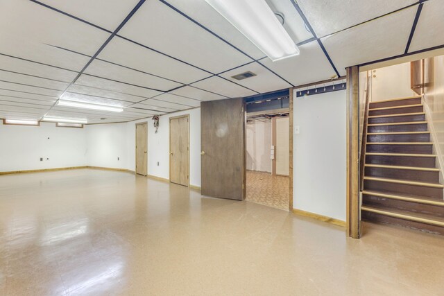 basement with a paneled ceiling