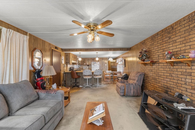 living room with ceiling fan, brick wall, light colored carpet, and wooden walls