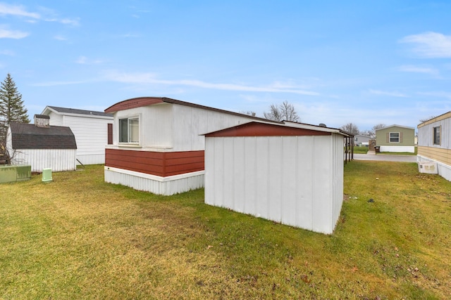 view of outbuilding featuring a yard