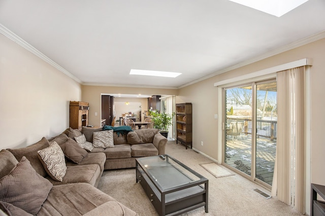 carpeted living room with ornamental molding and a skylight