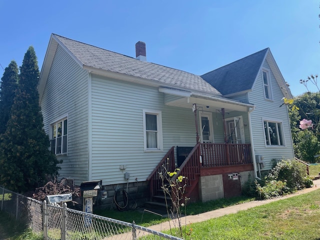 rear view of house featuring a porch