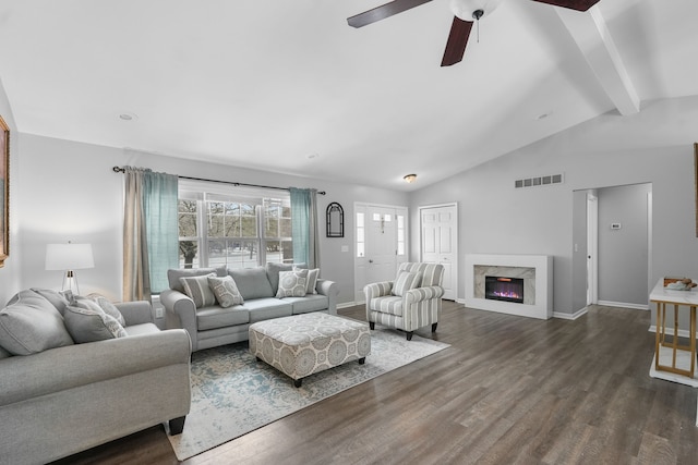 living room with a premium fireplace, dark wood-type flooring, vaulted ceiling with beams, and ceiling fan