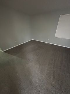 empty room featuring dark colored carpet