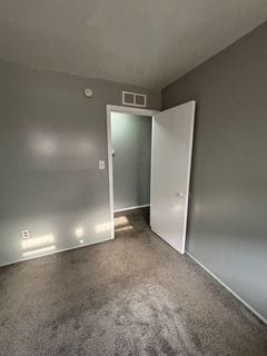 unfurnished room featuring carpet