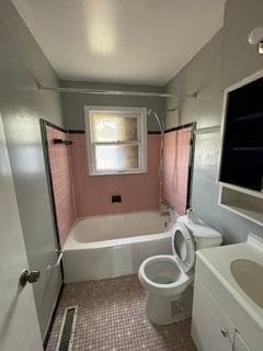 full bathroom with shower / tub combination, tile patterned flooring, vanity, and toilet