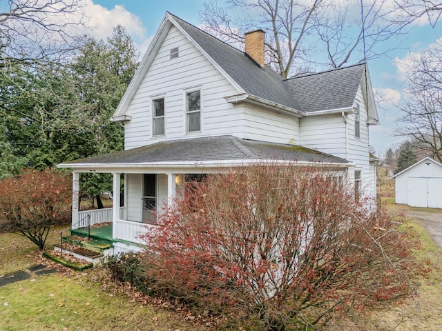 view of front of house with a porch and a storage unit