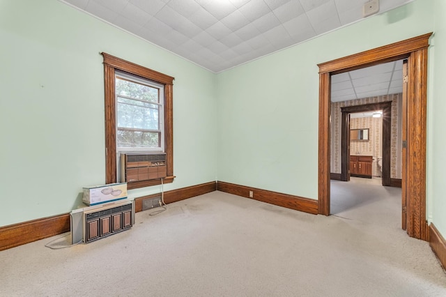 empty room featuring cooling unit and light carpet