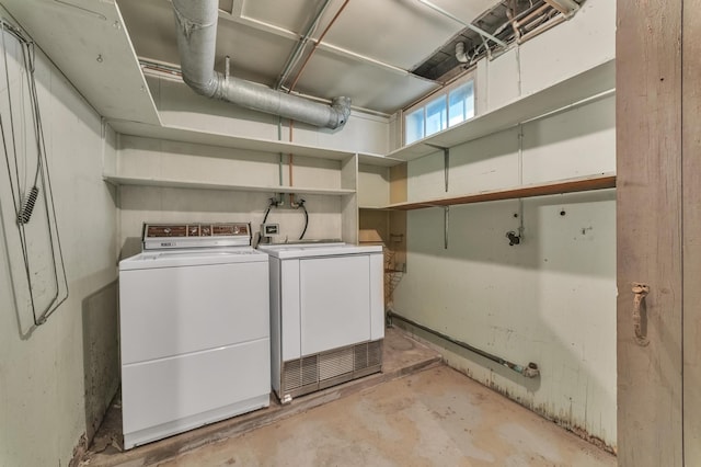 clothes washing area featuring separate washer and dryer