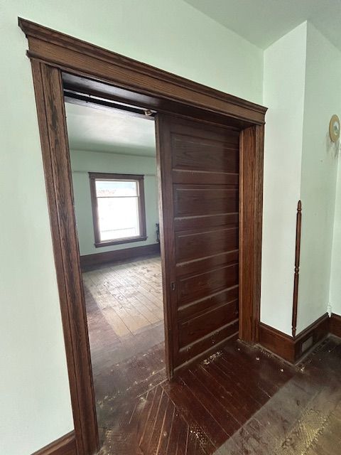 hall with dark hardwood / wood-style flooring