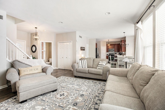 living room featuring dark hardwood / wood-style flooring and a notable chandelier