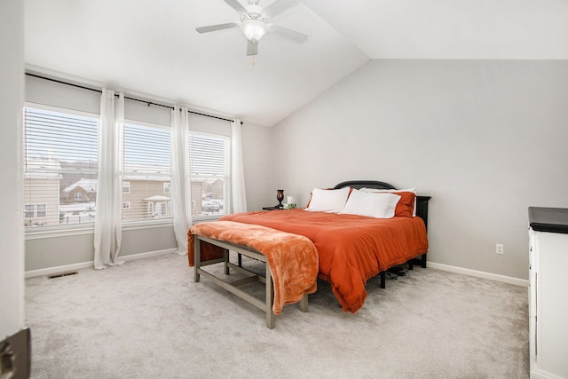 bedroom featuring lofted ceiling, light carpet, and ceiling fan