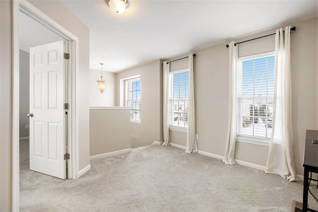 unfurnished room with light colored carpet