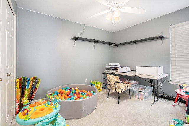 game room with light colored carpet and ceiling fan