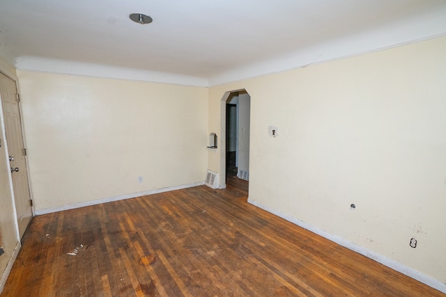 spare room featuring dark wood-type flooring