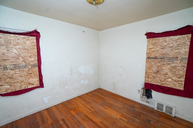 spare room featuring dark hardwood / wood-style floors