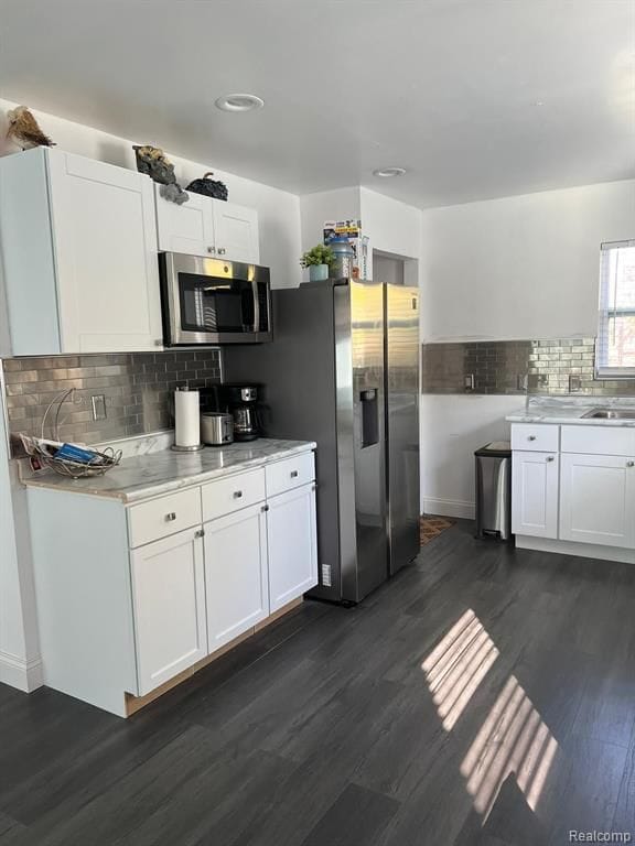 kitchen featuring dark wood finished floors, white cabinetry, stainless steel appliances, and light countertops