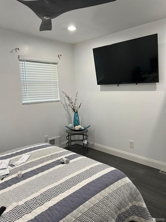 bedroom featuring dark wood-type flooring, recessed lighting, and baseboards