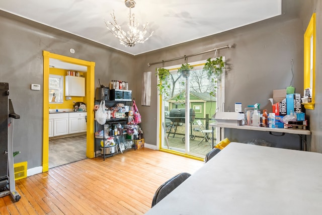 bedroom featuring a chandelier and light wood-type flooring