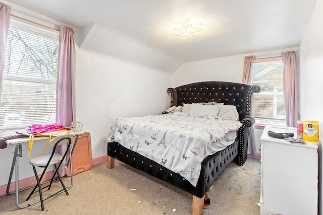 carpeted bedroom with lofted ceiling