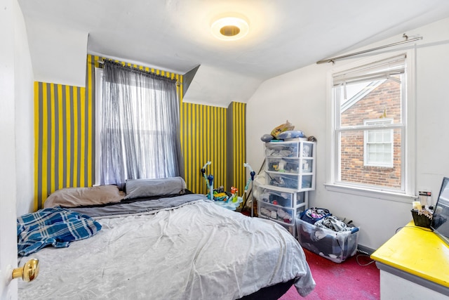 bedroom with carpet floors and vaulted ceiling