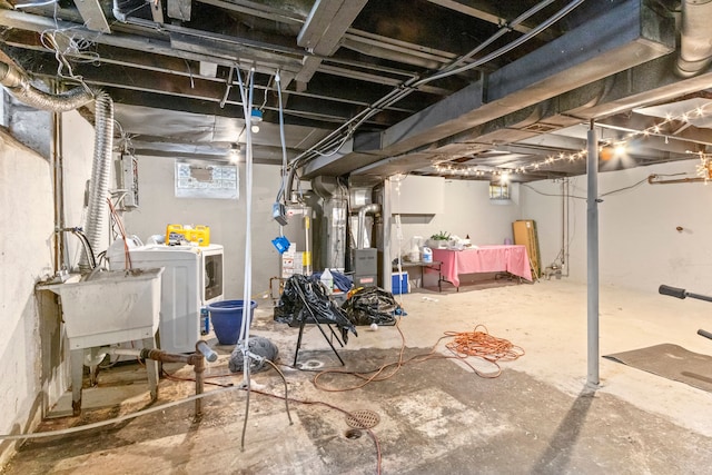 basement with gas water heater, separate washer and dryer, heating unit, and sink