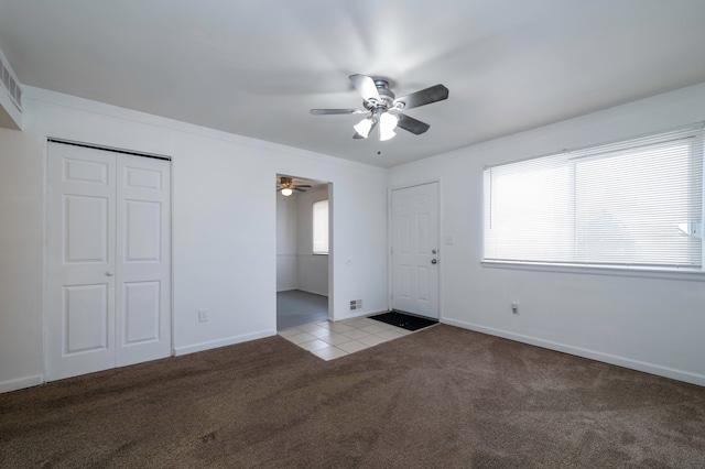 unfurnished bedroom featuring light carpet and ceiling fan