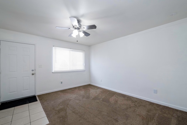 carpeted spare room featuring ceiling fan