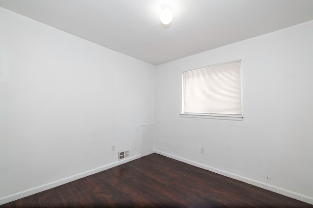 unfurnished room featuring dark wood-type flooring