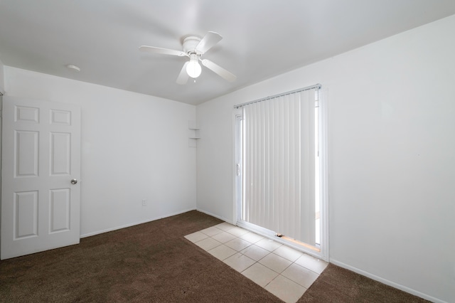 carpeted empty room featuring ceiling fan