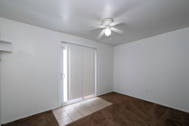 carpeted spare room with ceiling fan