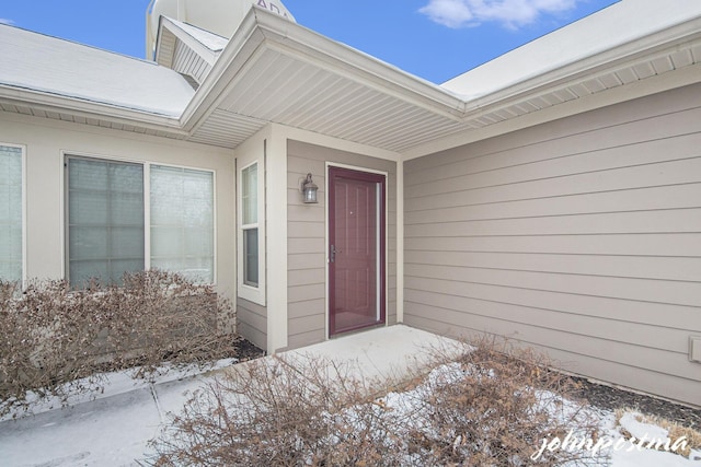 view of snow covered property entrance