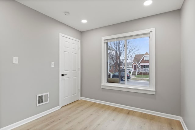 empty room with light hardwood / wood-style floors