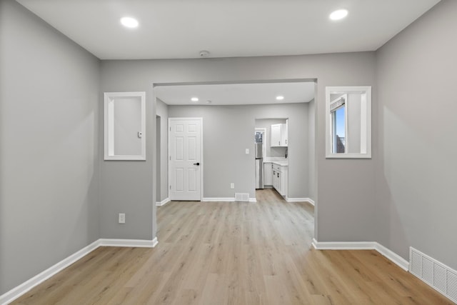 unfurnished room with light hardwood / wood-style floors