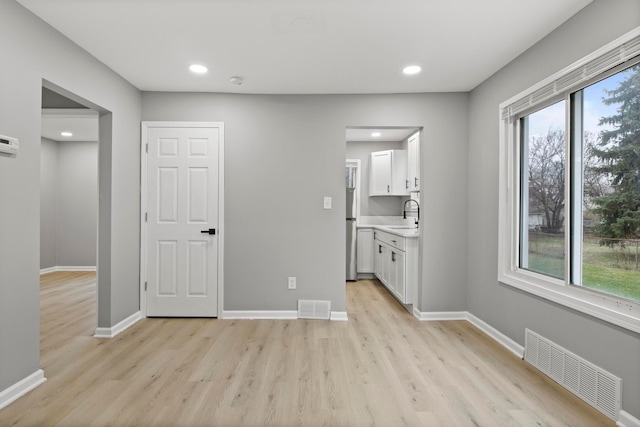 interior space featuring sink and light hardwood / wood-style floors