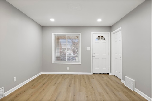 foyer entrance with light hardwood / wood-style floors