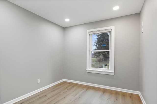 unfurnished room featuring light hardwood / wood-style floors and plenty of natural light