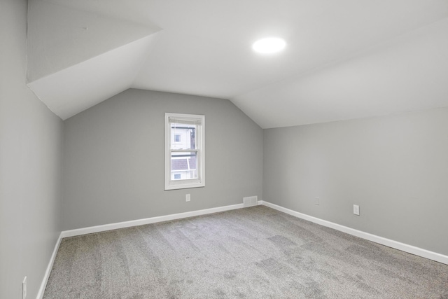 additional living space with carpet and lofted ceiling