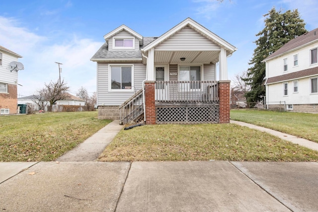 bungalow-style house featuring covered porch and a front lawn