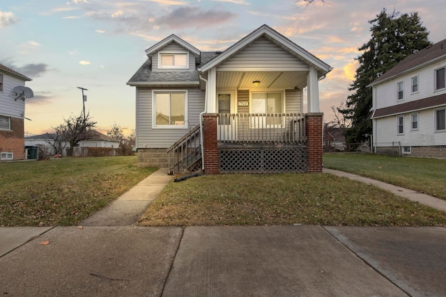 view of front of home with a yard and covered porch