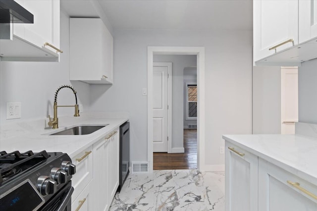 kitchen featuring dishwasher, white cabinetry, sink, light stone countertops, and stainless steel gas range