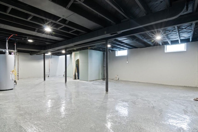 basement with a wealth of natural light and gas water heater