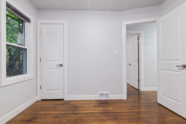 unfurnished bedroom featuring dark hardwood / wood-style floors