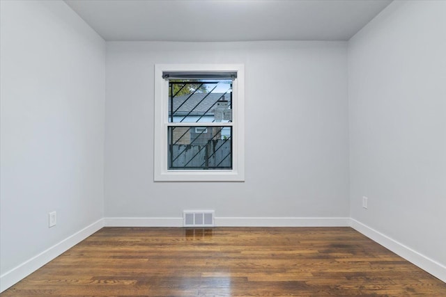 spare room featuring dark hardwood / wood-style floors