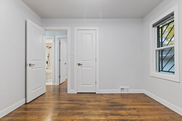 spare room with dark hardwood / wood-style floors