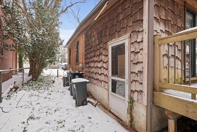 view of snow covered exterior with central AC unit