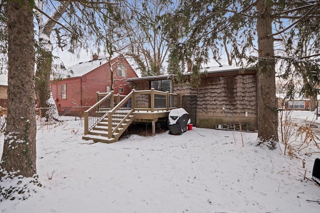 snow covered rear of property featuring a wooden deck