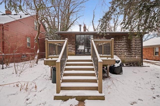 view of snow covered back of property